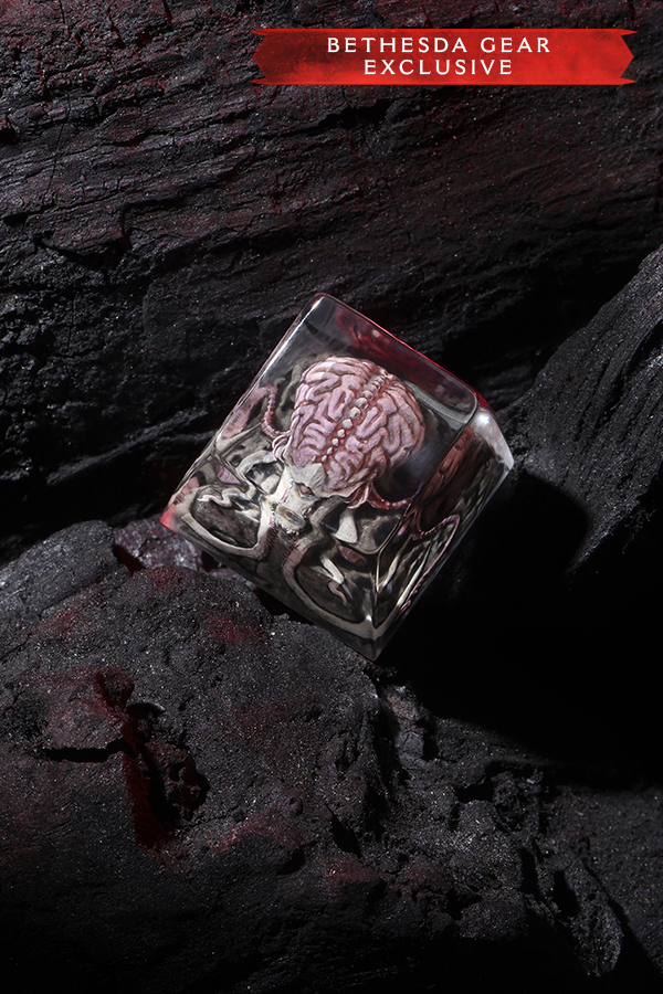 Brain in a glass container on dark stone surface with 'Bethesda Gear Exclusive' label.