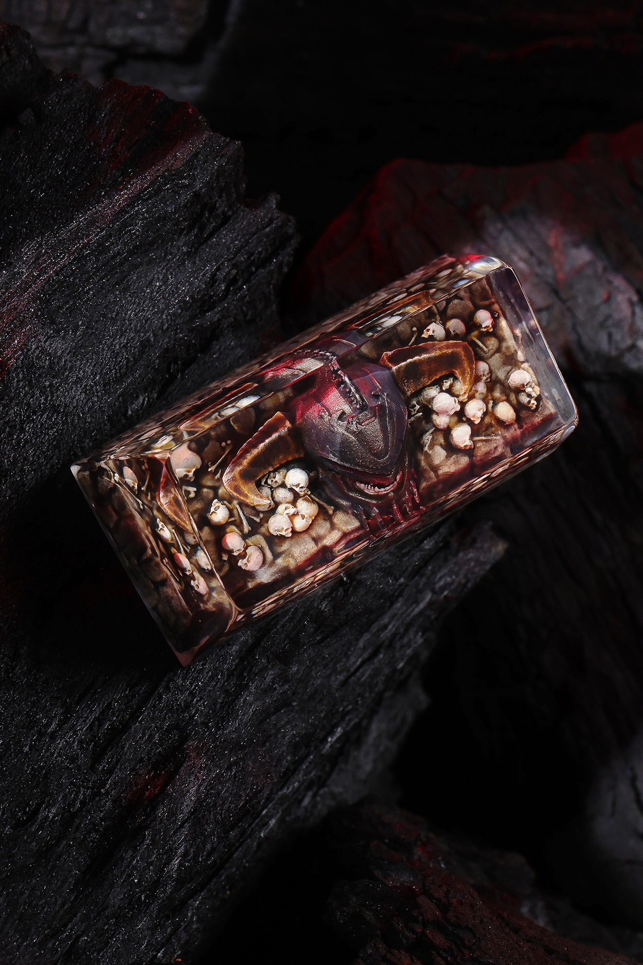 Decorative box with a red heart and small figurines on a dark background