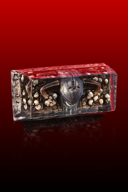 Decorative box with a face design on a red background