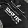 Image: Vault-Tec Hoodie detail view of zipper, front embroidery, and front logo