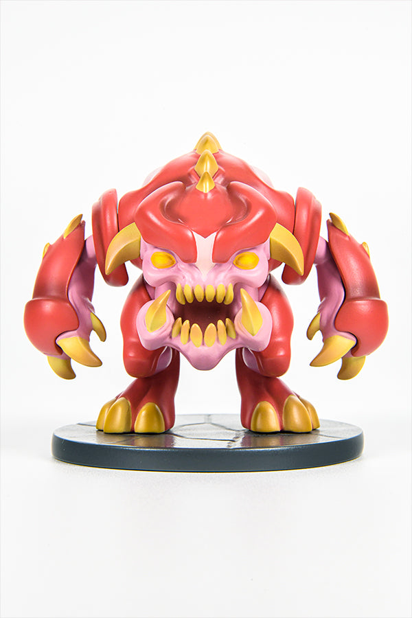Front view of the DOOM Eternal Pinky Mini Collectible Figure, a 3 x 3 x 3.15” Polyresin figure of a pink demon with a round body, sturdy legs, burly arms, claws, horns, spikes, and a killer look in its face and eyes. Limited production of only 900 worldwide. Modeled after an in-game collectible.