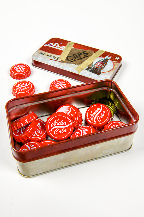 Image of the Fallout Bottle Cap Series Nuka Cola with Collectible Tin with some caps laying on a table