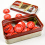Image of the Fallout Bottle Cap Series Nuka Cola with Collectible Tin with some caps laying on a table