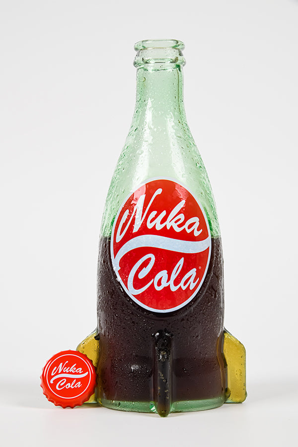 Front view of Nuka Cola Glass Bottle & Cap halfway filled with soda